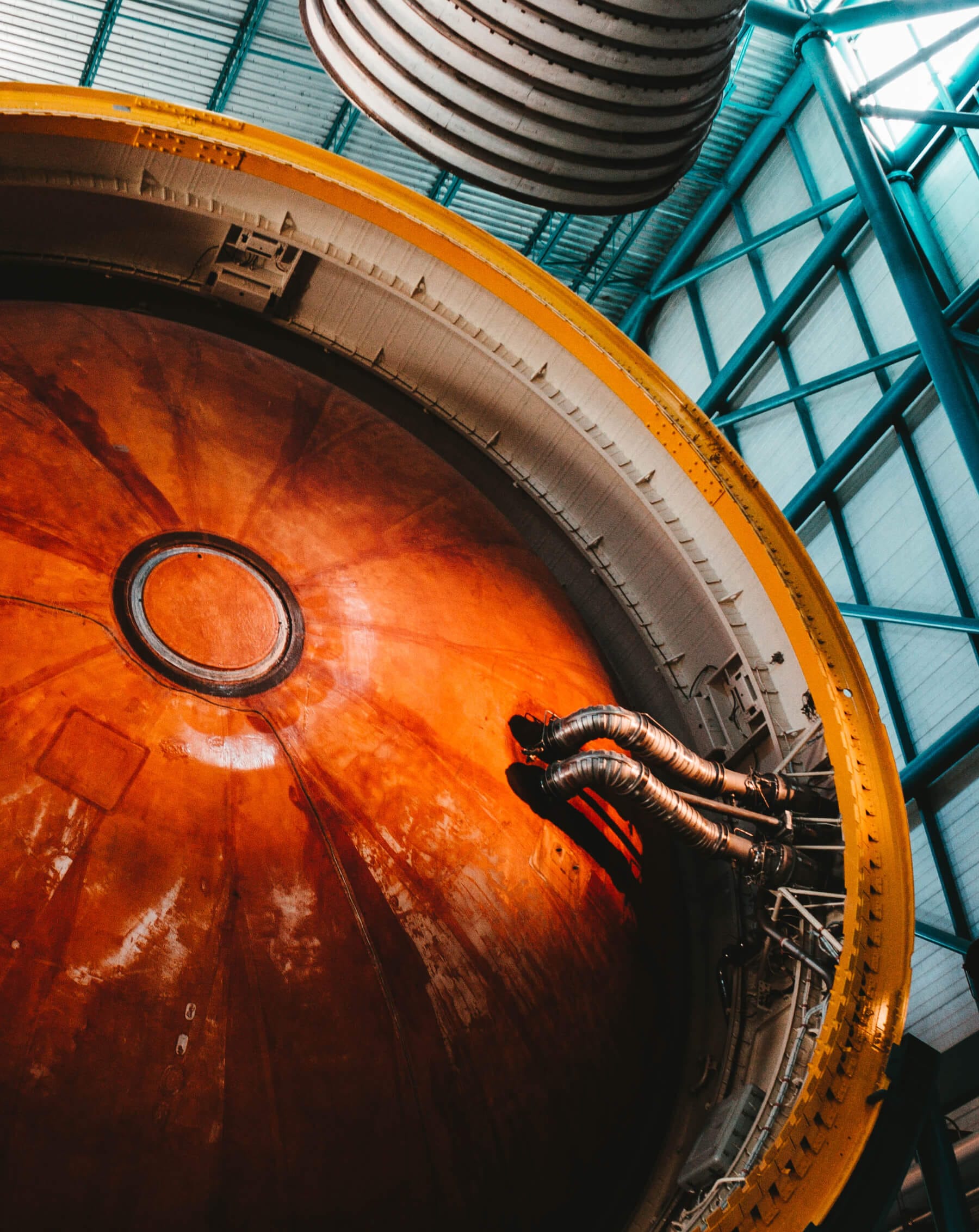 Large aerospace component viewed from below in industrial facility