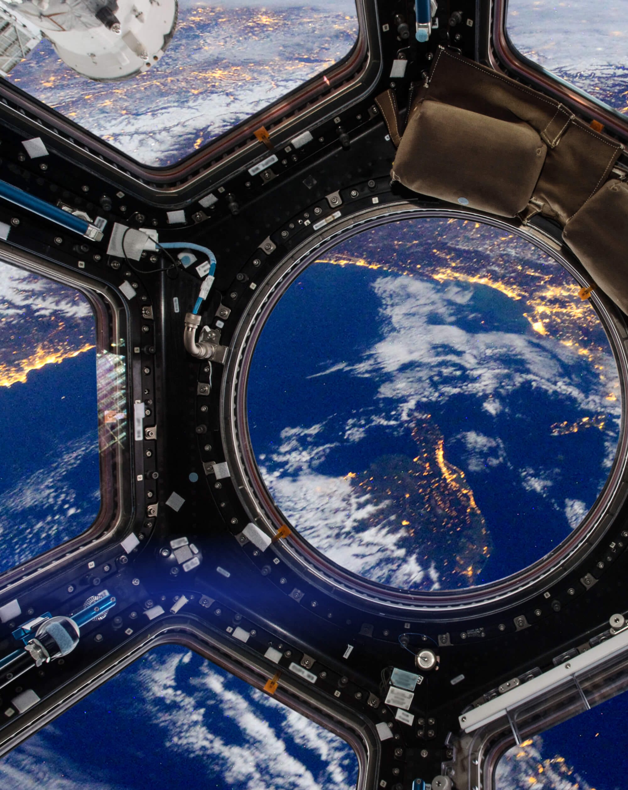 View from spacecraft showing Earth’s curvature through modular observation window